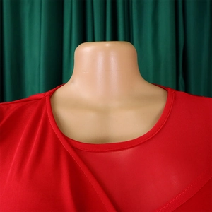 Detailed view of the red round neck dress with sheer mesh patchwork and elastic fabric