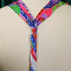 Detail of colorful silk halter tie featuring high-saturation abstract floral patterns