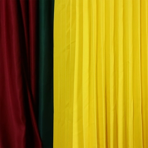 Vue macro détaillée de la texture du tissu plissé en jaune, vert foncé et rouge vin