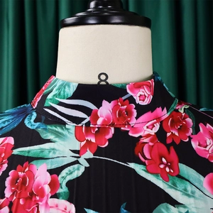 Detail of high collar neckline on floral print dress featuring red peony patterns