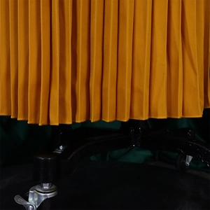 Detailed view of ginger yellow pleated fabric showing crisp pleats and premium texture