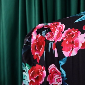Close-up of puff sleeve detail and vintage floral print on elegant pleated dress