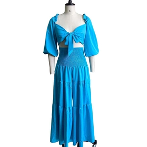 Detail of blue summer set showing lace-up crop top with lantern sleeves and layered pants