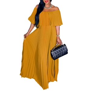 Detail of elegant mustard yellow pleated off-shoulder evening dress with long skirt