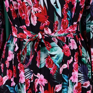 Detail of floral print maxi dress with pleated fabric and a waist tie-up bow