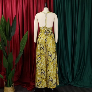 Detail of cross tie-up waist and backless design on yellow paisley print jumpsuit
