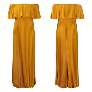 Detail view of the fine vertical pleats on the mustard yellow off-shoulder jumpsuit