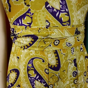 Detail of paisley print jumpsuit with high waist gathers and adjustable tie waist