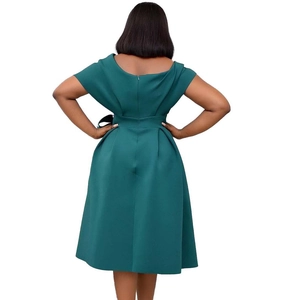 Detail of the back design on this dark green V-neck dress with a pleated waist