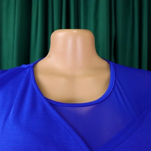 Close-up of royal blue round neck with mesh patchwork and textured knit fabric