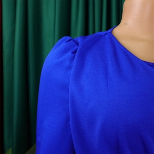 Detail of royal blue mesh puff sleeve and textured fabric on casual spring dress