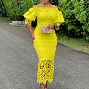 Detail of elegant yellow off-shoulder dress featuring lace embroidery and puff sleeves