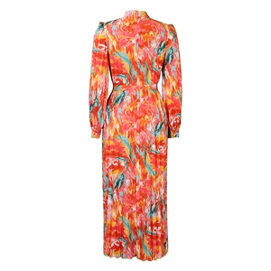 Detailed close-up of vibrant abstract marble print and pleated waist of the long dress