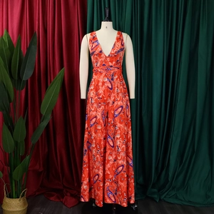 Detail of red paisley print fabric on a bohemian sleeveless V-neck maxi dress
