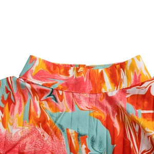 Detailed view of high neck collar with vibrant abstract marble print and pleated texture