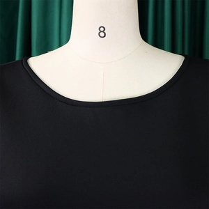 Close-up detail of the classic round neckline and stitching on this black knit dress