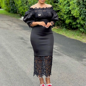 Detail of elegant black off-shoulder dress with intricate lace stitching and a bow detail