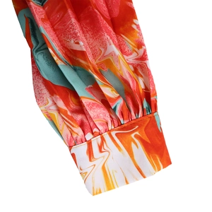 Detail of smocked cuffs and marble print on long sleeve chiffon dress for women