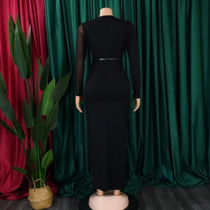 Detail of sheer mesh sleeves and slim belt on black knit maxi dress with a round neck