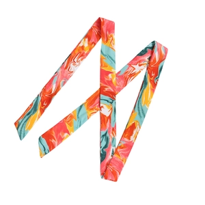 Detail of multi-colored silk-like twilly scarf with abstract marble pattern on white base