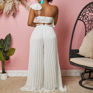 Detail of white off-shoulder ruffle top and high-waisted pleated wide-leg pants from behind