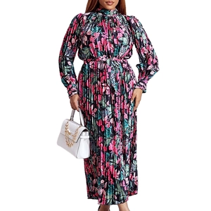 Detail of long sleeve pleated maxi dress with vibrant floral print and waist tie