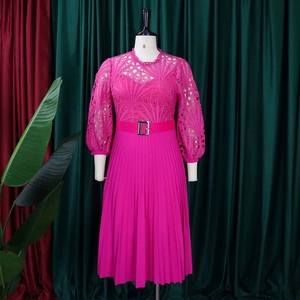 Detail of rose red lace cutout bodice with pleated skirt and belted bubble sleeves