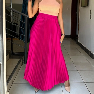 Detail of high waist pleated maxi skirt in rose red with elastic waistband and satin finish