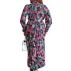 Back view of a plus-size long sleeve pleated dress with all-over floral print design