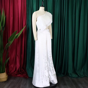 Macro view of white pleated off-shoulder top and matching wide-leg pants on a mannequin