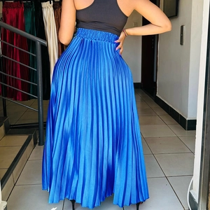 Macro detail of royal blue pleated maxi skirt with metallic silk finish and elastic waist