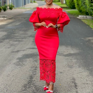 Detailed view of puff sleeves and intricate lace stitching on a red off-shoulder gown
