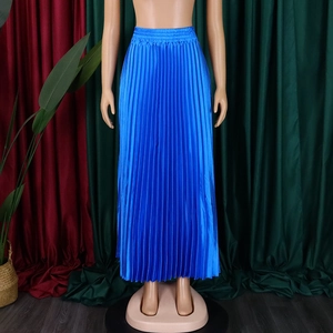 Detail showing high-waisted pleated long skirt in bright blue silk-like fabric with elastic waist