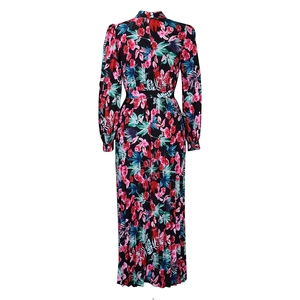 Detail view of the back of a black floral maxi dress with pink roses and green leaves