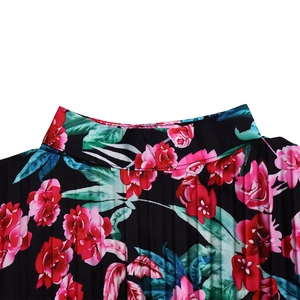 Close-up of pleated stand collar on long sleeve dress with red floral print
