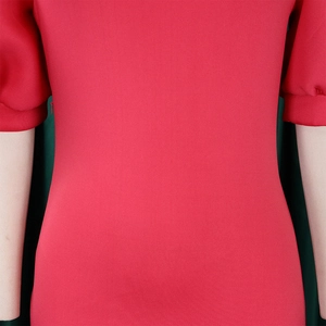 Detail of red puff sleeve dress with side invisible zipper and smooth textured fabric