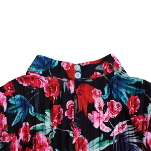 Detailed view of the high neck design with vertical pleats and back button closure