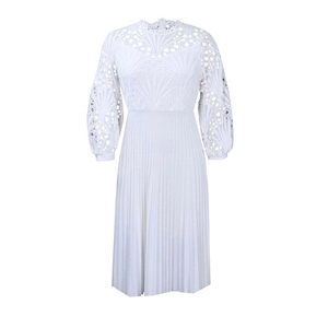 Close-up of intricate lace details and hollow embroidery on white pleated dress