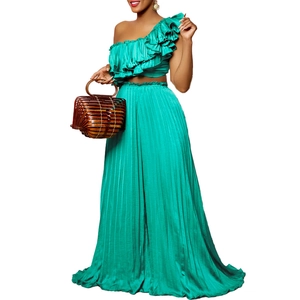 Detail view of emerald green one-shoulder ruffled crop top and pleated wide-leg trousers set