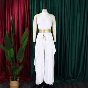 Detail of white halter neck top with asymmetrical layers and pleated wide-leg pants