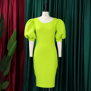 Detail view of fluorescent green puff sleeves and fitted round neck dress fabric