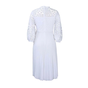 Detail view of the lace back and pleated skirt of this white summer maxi dress
