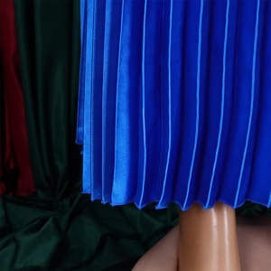 Detailed close-up of blue pleated satin skirt hem showing fine fabric texture and stitching