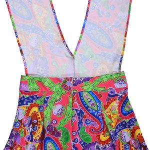 Close-up of vibrant paisley print jumpsuit with V-shaped back and hidden zipper detail