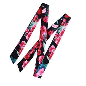 Close-up of floral print satin twilly scarf with vibrant pink flowers on black background