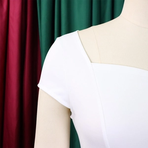 Détail de l'encolure carrée asymétrique et de l'épaule d'une robe crayon blanche chic