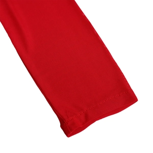 Detailed shot of sheer red mesh sleeve cuffs with professional stitching on the dress