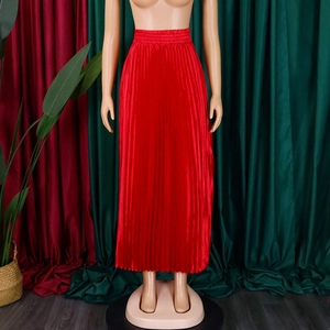 Detailed view of red pleated satin skirt with high waist design and elegant silk texture