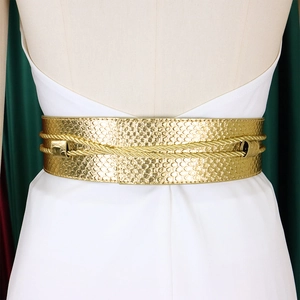 Detail of a luxury gold wide belt with scale texture and double braided rope decoration