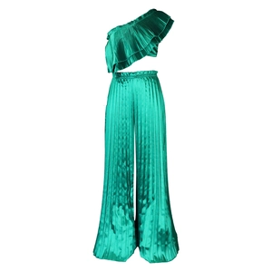 Detail of emerald green pleated satin fabric with tiered ruffles and elastic waist